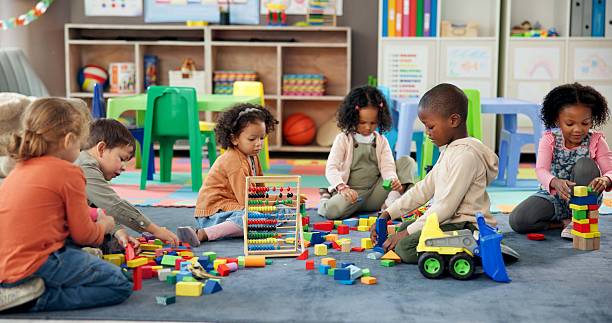 Pre-K children collaborating with colorful blocks in a classroom
